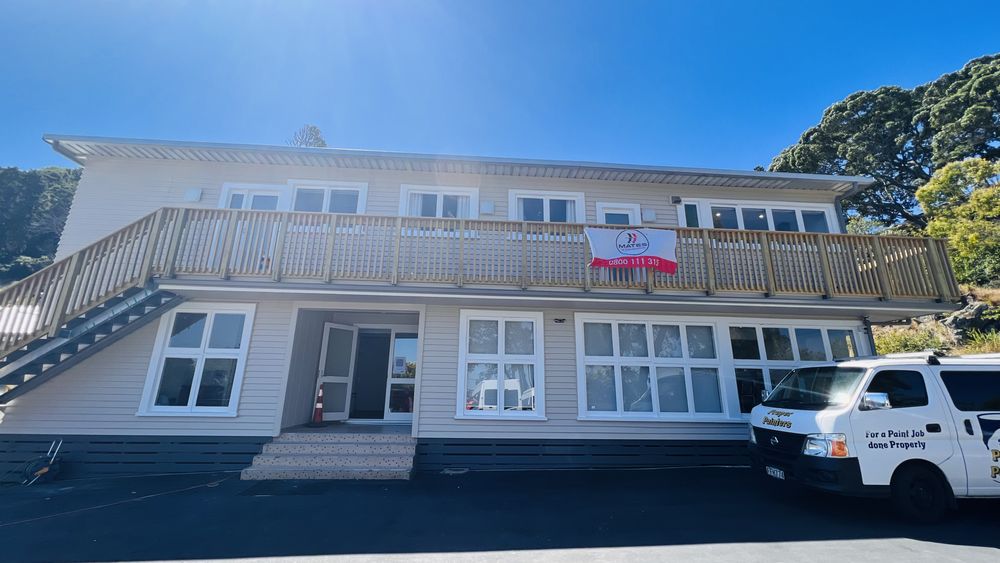 Restored bay window seat with natural timber overlooking Auckland garden