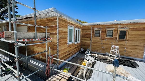 Restored French doors showing natural honey timber after paint stripping