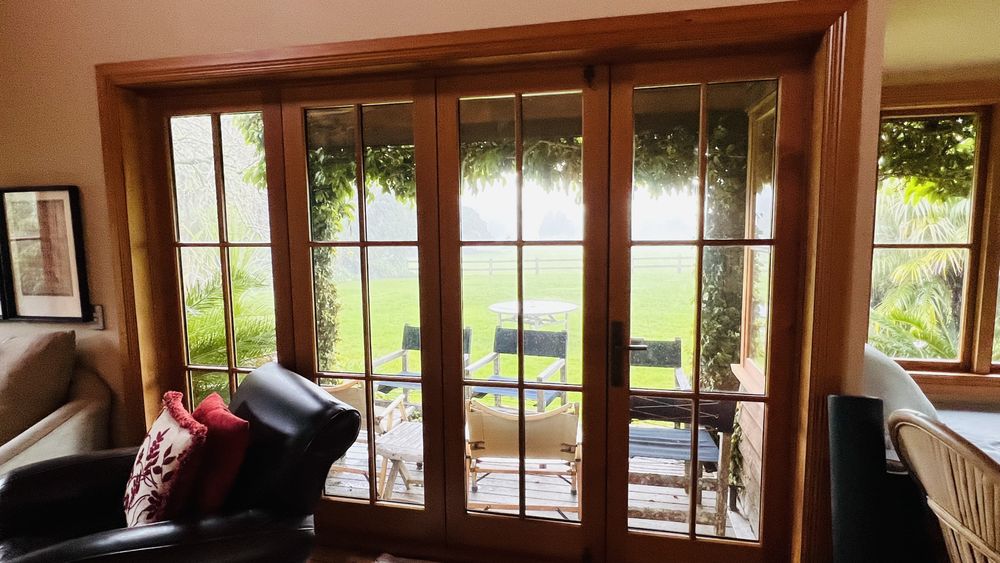 Auckland Paint Stripping crew in full PPE stripping villa weatherboards with HEPA extraction